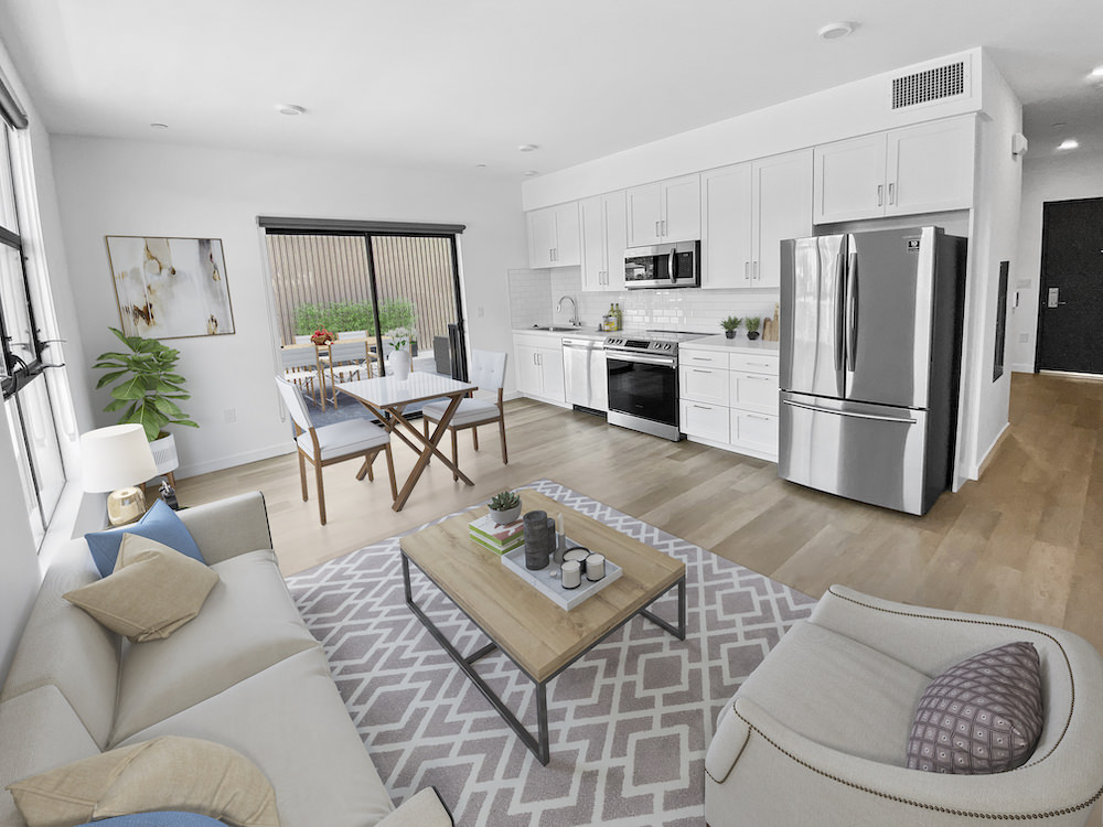 Spacious well lit living room with wood floors 