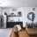 living area that includes kitchen and bright lighting