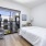 bedroom with a large window/patio-style and modern decor