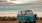 lifestyle image of a bus parked beside the ocean