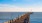 image of a long pier that stretches over the open ocean