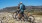 image of people on bicycles in a rocky environment